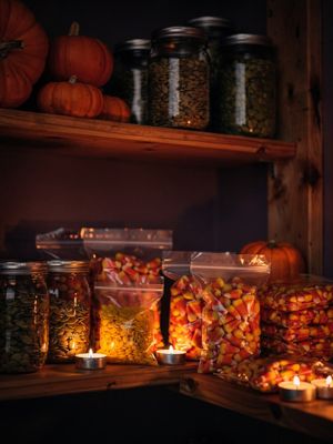 Generated still: a candlelit pantry shelf
